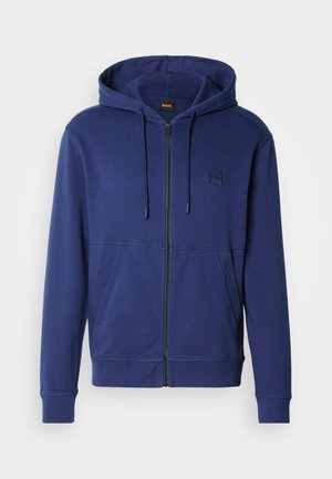 Marineblauwe hoodie gemaakt van zachte stof, met een volledige ritssluiting, capuchon met trekkoord en voorzakken, voorzien van een klein logo op de borst.