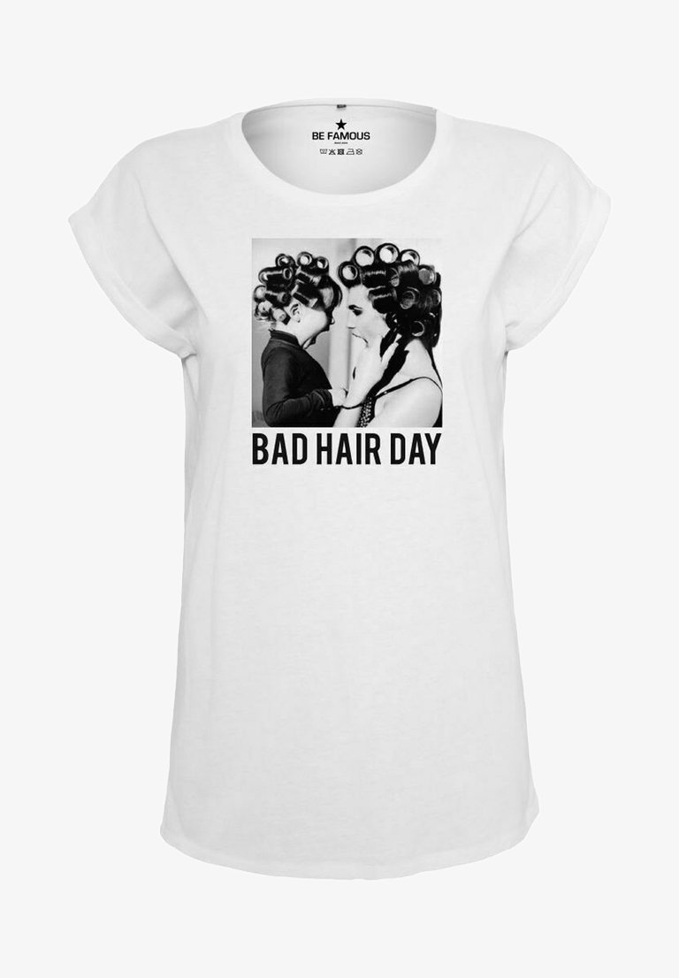 White t-shirt featuring a black and white graphic of two individuals with curlers, accompanied by the text "BAD HAIR DAY." Short sleeve design.