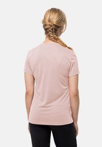Rosa kortärmad t-shirt med avslappnad passform och mjuk textur; bakifrån visas en rundad halsringning och mjuk drapering.