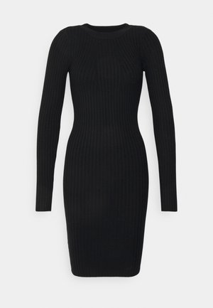 Robe noire côtelée à manches longues et col rond. Coupe ajustée, confectionnée dans un tissu extensible, texture lisse sur toute la surface.