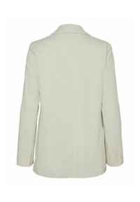 Light beige corduroy blazer with a notched lapel, single vent at the back, and buttoned cuffs. Smooth texture and tailored fit.