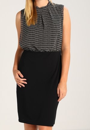 Black sleeveless dress with a patterned top featuring a high neckline and pleats, smoothly transitioning to a fitted black bottom.