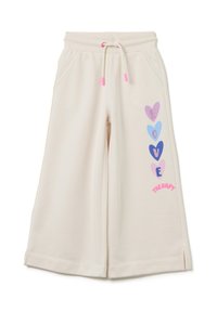 Crème kleurige sweatpants met een relaxte pasvorm, voorzien van een trekkoord in de taille, zijzakken en kleurrijke hartafbeeldingen op één been.