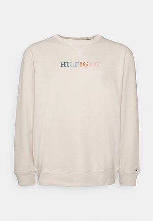 Kremowa bluza z długim rękawem, okrągłym dekoltem i wielokolorowym haftowanym napisem "HILFIGER" na klatce piersiowej.