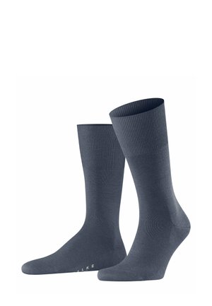 Dark gray crew-length socks with ribbed tops, displayed standing upright against a white background. Subtle branding visible on the soles.