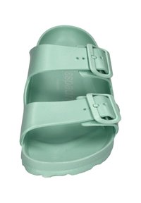Light green slide sandal featuring two adjustable straps with rectangular buckles, a textured surface, and a contoured footbed.
