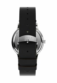 Timex watch with a stainless steel case and a black silicone strap. Features include a silver buckle and multiple adjustment holes.
