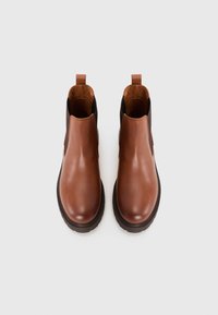 Brown leather ankle boots with elastic side panels, rounded toe, and a textured rubber sole for grip. Features a pull tab at the heel.