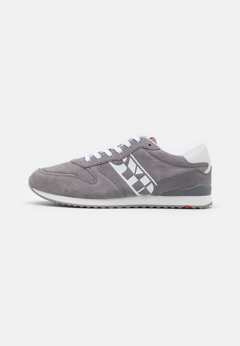 Gray suede sneaker with white and gray accents, featuring a checkered pattern on the side, a white rubber sole, and round laces.