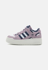 Low-platform Adidas sneaker in pink and navy with white stripes, perforated toe, and textured sole on a white background.