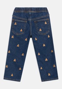 Tumesinised teksapüksid elastse vöökohaga, millel on hajutatud heledaid pruunikarva karu tikandeid nii tagaküljel kui esiküljel.