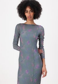 Long-sleeve dress in soft, textured fabric, featuring a blue-gray base with purple floral patterns and a fitted silhouette.