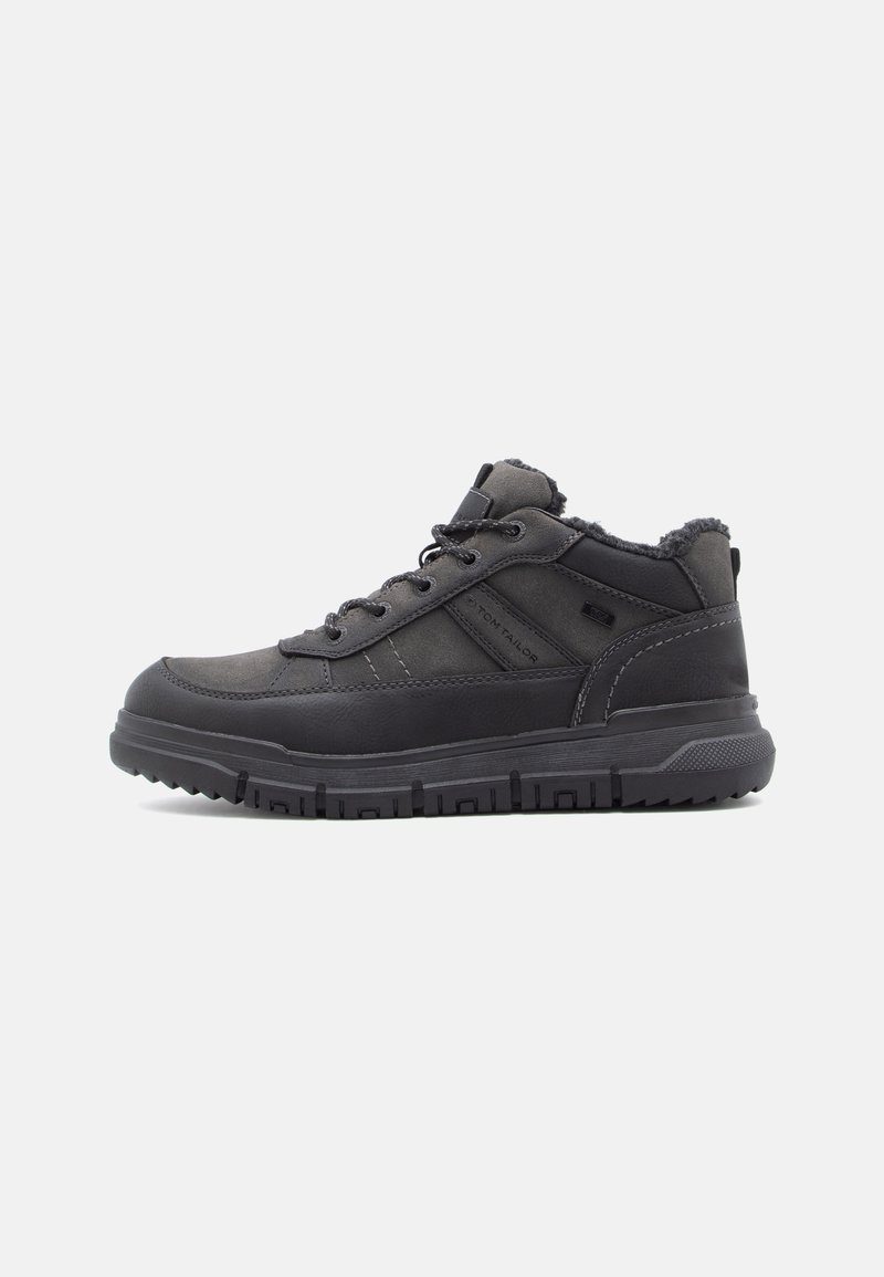 Black high-top shoes made of synthetic material with a textured finish. Features include sturdy laces, a padded collar, and rugged sole.
