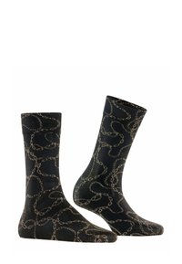 Schwarze Socken mit einem strukturierten, metallisch goldenen Kettenmuster, einer glatten Oberfläche und verstärkten Bündchen für Langlebigkeit.