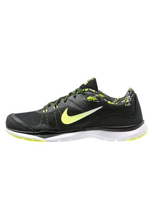 Czarny i neonowo-żółty but sportowy Nike z białą podeszwą i wzorzystą podszewką, widoczny od zewnętrznej strony.