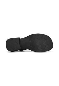 Suela de zapato negra con un patrón texturizado ondulado, fabricada en goma duradera, con un borde suave y una parte del talón sólida sin ninguna marca visible.