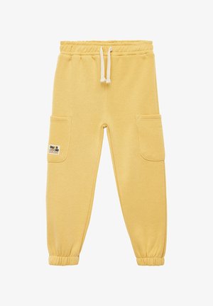 Pantalons de survêtement jaunes en tissu doux, avec deux poches latérales et une taille à cordon de serrage. Poignets aux chevilles ; patch logo sur la poche.