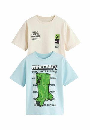 Two Minecraft-themed kids' T-shirts, one cream with pixelated faces and text, one blue featuring a large green Creeper and repeated text.