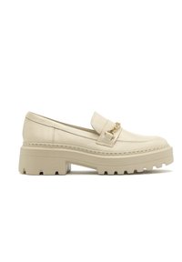 Beige leather loafer with a chunky sole, featuring a decorative gold chain on the vamp and subtle stitching details.