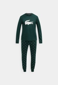 Zielony bawełniany zestaw piżamy z długim rękawem, z białą grafiką krokodyla na górze oraz pasujące spodnie z małymi wzorami krokodyli.