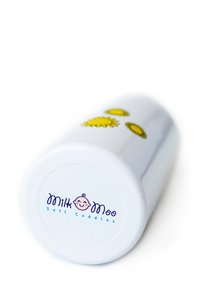 Ceramic cup with a smooth white surface, featuring yellow flower designs. Base displays "Milk Moo Soft Cuddles" in blue text.