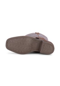 Brown leather boot with a textured rubber sole featuring a zigzag pattern. Includes a side buckle detail for added design.