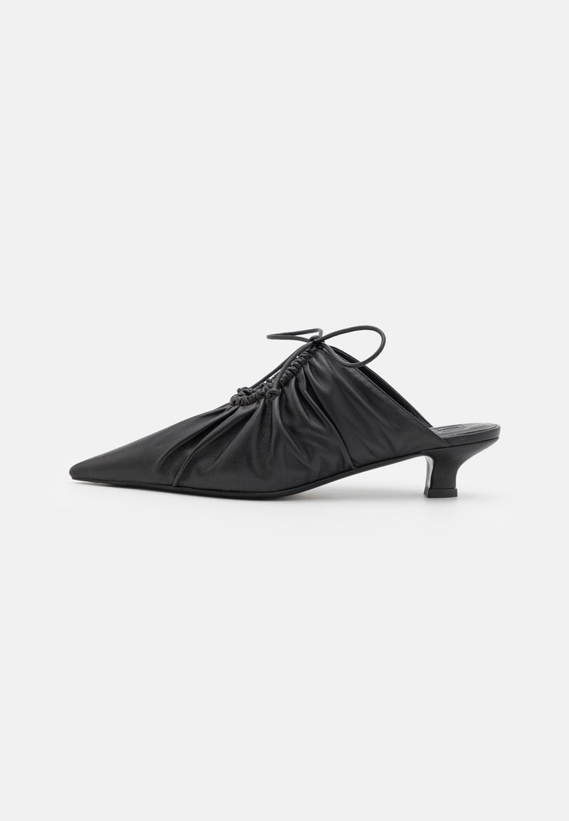 Black leather slip-on mules with a pointed toe, gathered texture, and a small kitten heel. Features a drawstring detail at the opening.