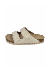 White, fuzzy sandals with two adjustable straps, cork footbed, and a textured sole. Features a soft, plush upper and durable outsole.