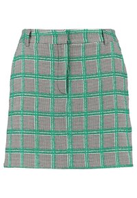 Jupe à carreaux noir et blanc avec des lignes de grille vertes, dotée d'une coupe droite et d'une texture lisse. Ceinture pour un ajustement sûr.