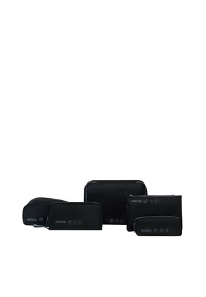 Set of five black travel organizer pouches of varying sizes with white icons and American Tourister branding on a white background.