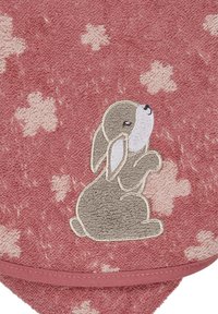 Pink towel featuring a textured fabric with floral patterns. A gray embroidered rabbit is prominently displayed on the surface.