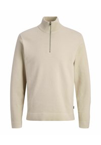 Pull en tricot beige à manches longues avec un col montant et une fermeture éclair mi-longue à l'avant.