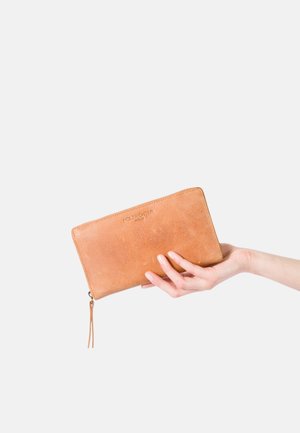 Tan leather wallet featuring a zipper closure, rectangular shape, embossed logo, and a decorative tassel on the zipper pull.