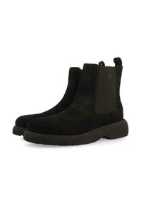 Botas de tobillo de ante negro con paneles laterales elásticos y una suela de goma texturizada y gruesa. Diseño simple con tiradores para poner y quitar fácilmente.