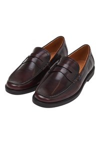 Braune Leder-Loafer mit glatter Oberfläche, dekorativem Band an der Vorderseite und Gummisohle für Grip und Haltbarkeit.