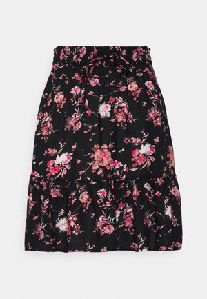 Sort nederdel med rynket talje og bindebånd, med pink, hvid og rød blomsterprint og flæsekant.