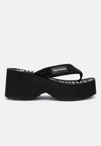 Black platform flip-flop featuring a thick sole, soft fabric strap, and textured footbed; "Juice Couture" logo printed on the insole.