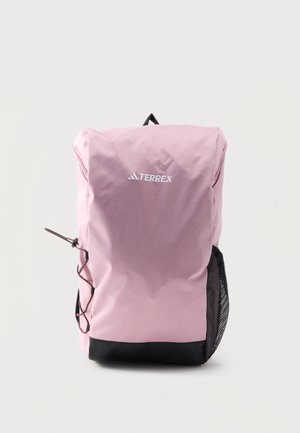 Mochila rosa para exteriores con base negra, bolsillo lateral de malla, cordón ajustable en el lateral y logo "TERREX" en el frente.