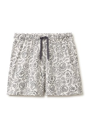 Weiße Shorts mit schwarzen, kreisförmigen Punktmustern und einem schwarzen Kordelzug am elastischen Bund.
