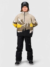 Φλις πουλόβερ σε μπεζ χρώμα με μοτίβα βουνών σε σκούρο γκρι και κίτρινο, με λαιμόκοψη σε σχήμα φου funnel, συνδυασμένο με μαύρα cargo παντελόνια και αθλητικά παπούτσια.