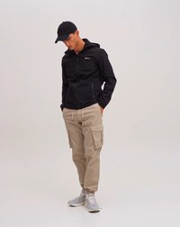 Black zip-up jacket with a hood, khaki cargo pants, and gray sneakers. Features include pockets on pants, simple design, and athletic fit.