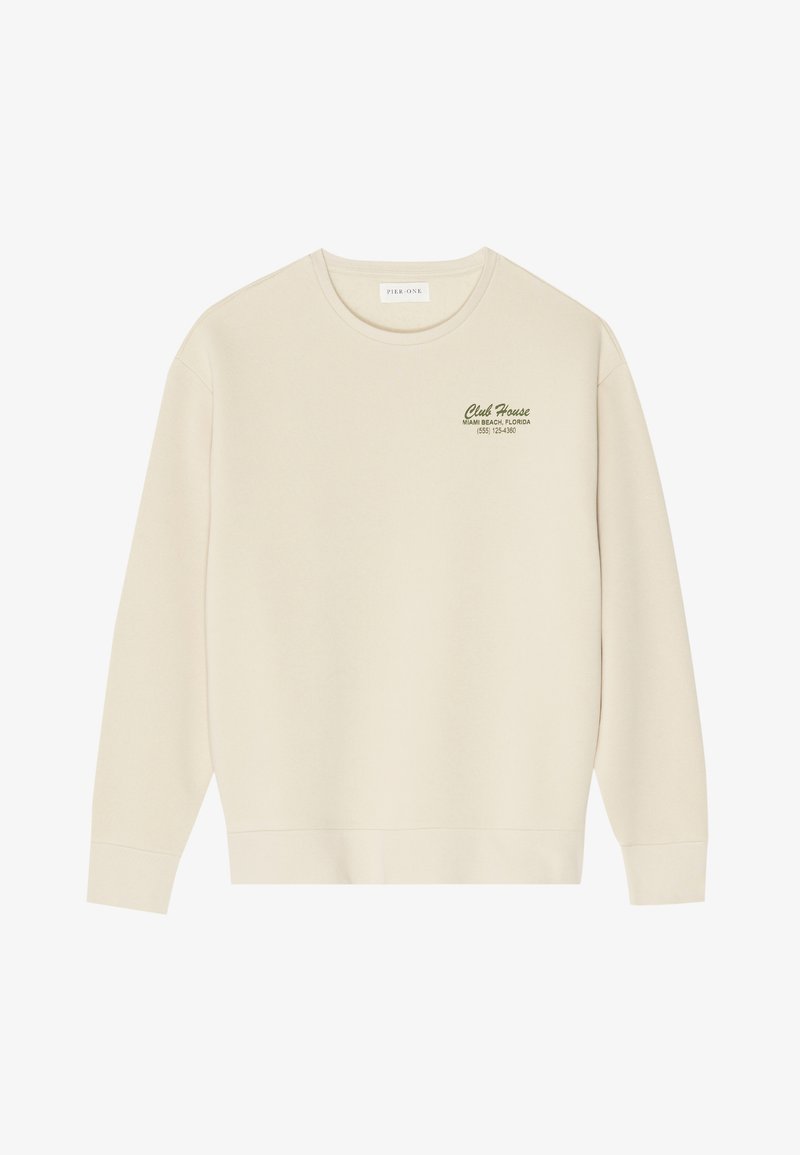 Beige sweatshirt with a crew neck, long sleeves, and a ribbed hem. Features green text stating "Club House Miami Beach, Florida" on the chest.