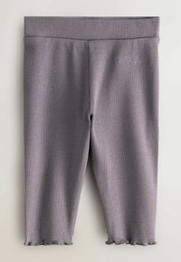 Grå ribbede leggings med en tætsiddende pasform. Blød tekstur, bølgede sømme og et diskret logo nær taljebåndet.