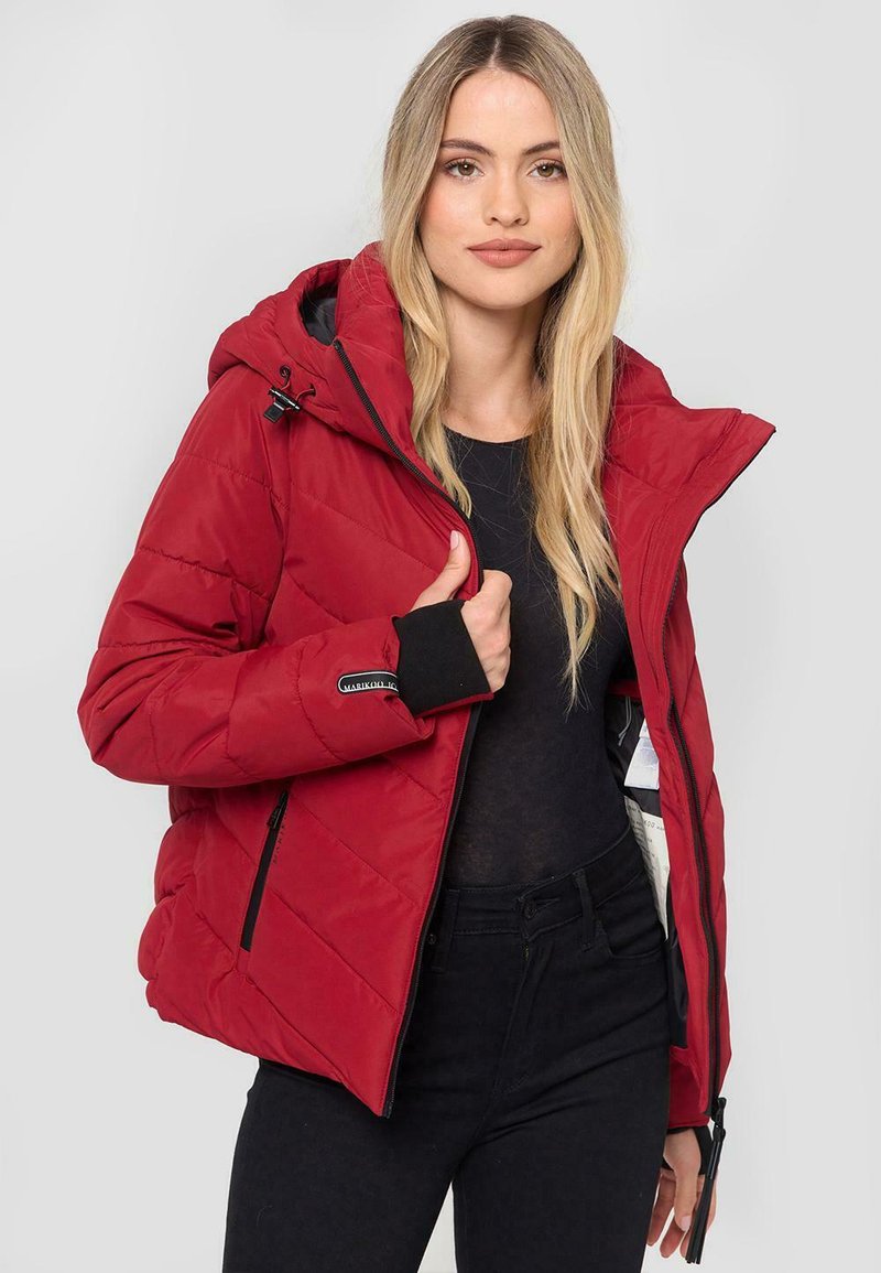 Red puffer jacket with a hood, featuring a zip closure, black accents on cuffs, and diagonal quilted design. Lightweight and warm material.