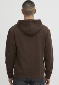 Brown hooded sweatshirt with a soft texture, fitted cuffs, and a kangaroo pocket. Features a simple design without visible logos or patterns.