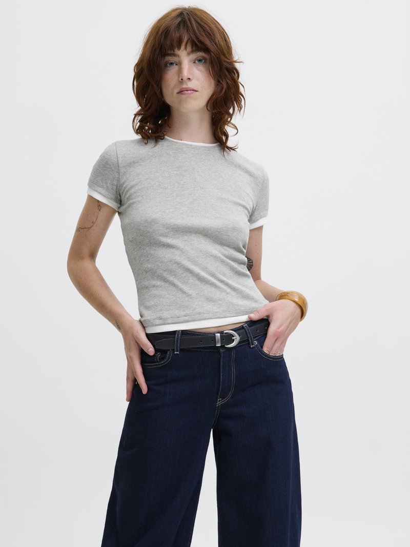 Gray short-sleeve t-shirt with white trim, paired with dark blue wide-leg jeans. A black belt and wooden bracelet complete the look.