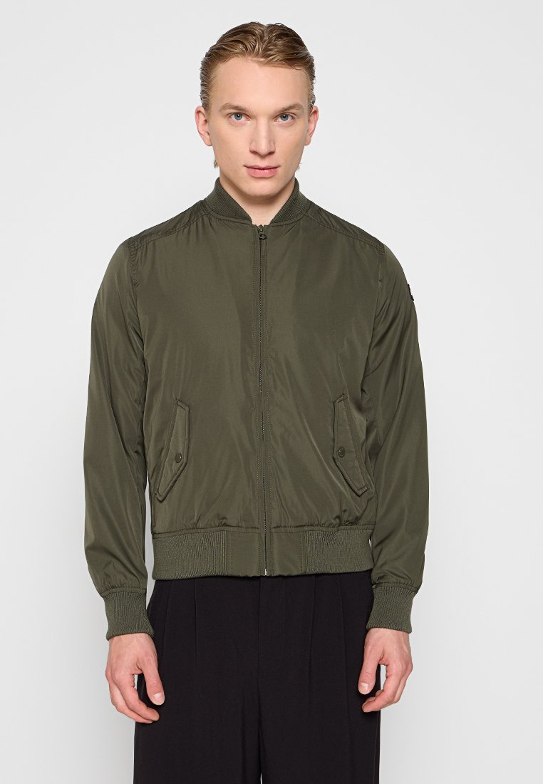 Veste bomber olive en tissu lisse, dotée d'une fermeture éclair à l'avant, de poignets et d'un ourlet côtelés, et de deux poches latérales avec rabats.