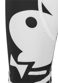 Leggings noir et blanc présentant un grand graphique de poisson, en matériau lisse et extensible, avec des accents contrastants le long des coutures.