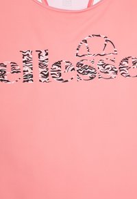 Haut de sport rose avec un logo audacieux présentant un motif zèbre noir et blanc. Tissu doux avec une coupe décontractée et un col rond.