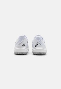 White athletic shoes with mesh and synthetic upper, rubber sole, and black logo accents. Features padded collar and heel for support.